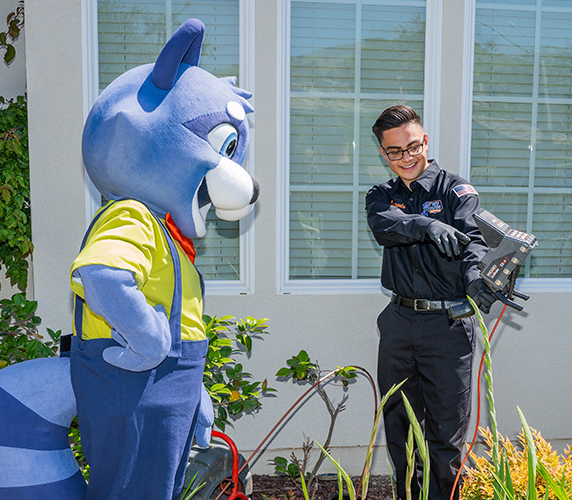 Mascot and technician having fun during a cable installation outside a house.
