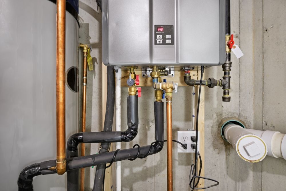 Tankless water heater system in a basement with copper and PVC pipes, efficient home heating solution.