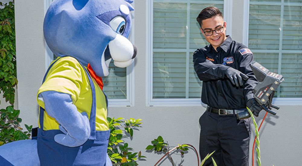 Mascot and technician having fun during a cable installation outside a house.
