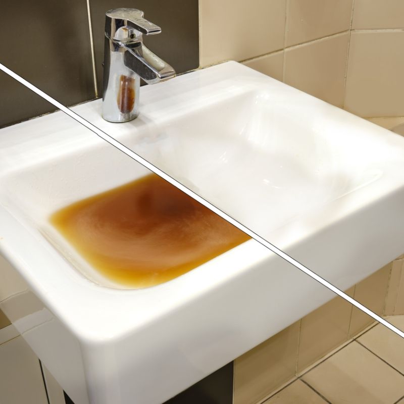 Dirty sink with brown water in a bathroom setting, highlighting plumbing issues and water quality concerns.