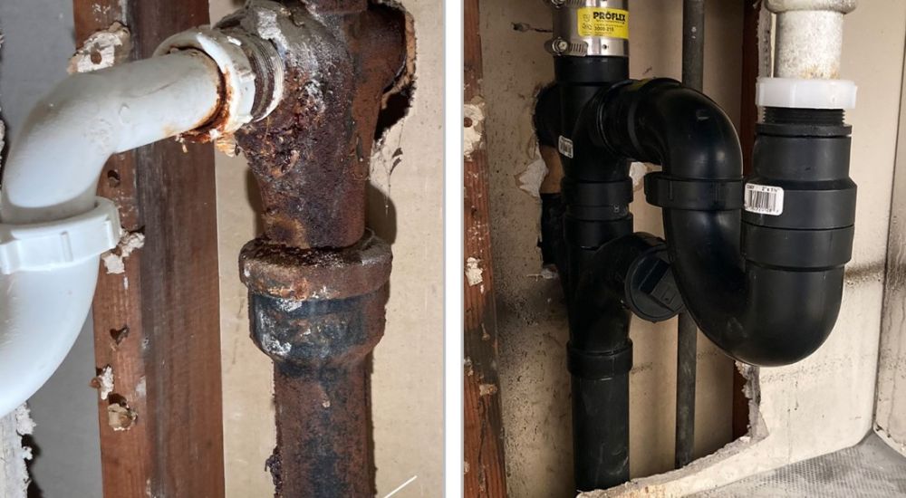 Old rusted pipe vs. new plastic plumbing repair in wall, showcasing before and after renovation.